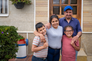 Latin family in front of their house.