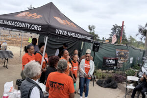 Press conference held at the rebuilding site of an NHSLA client.